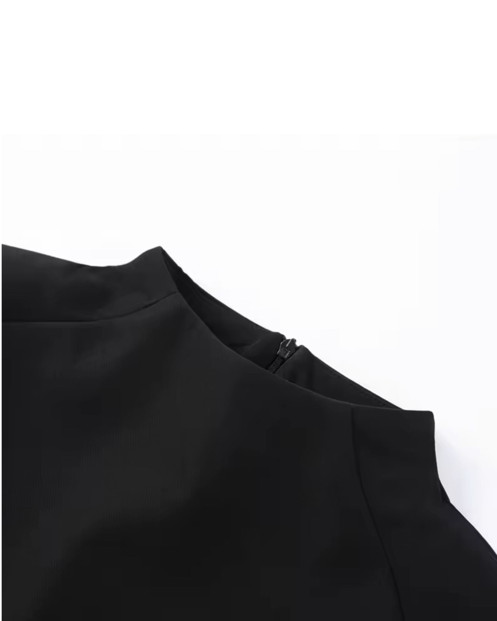 Close-up of black sculpted shoulder cape top with high collar - minimalist luxury womens fashion 