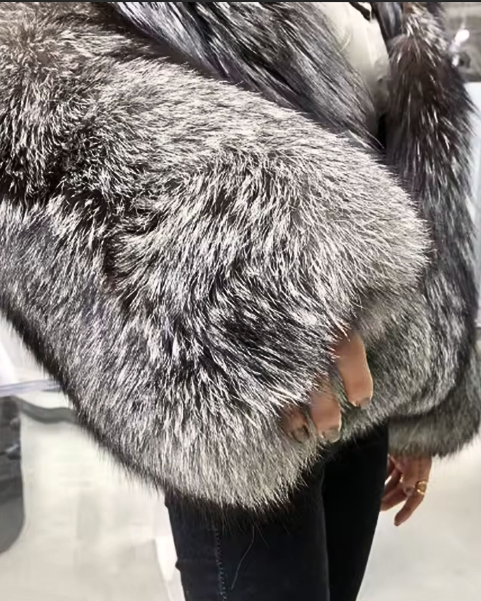 Close-up of silver fox faux fur sleeve - luxury grey faux fur jacket detail 
