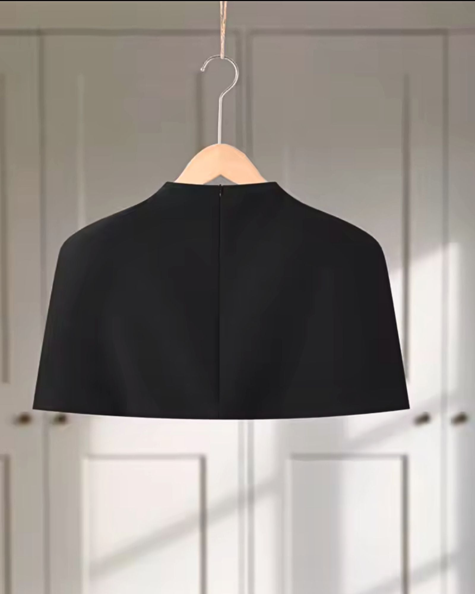 Back view of black sculpt shoulder cape top with structured collar - minimalist luxury womens top 